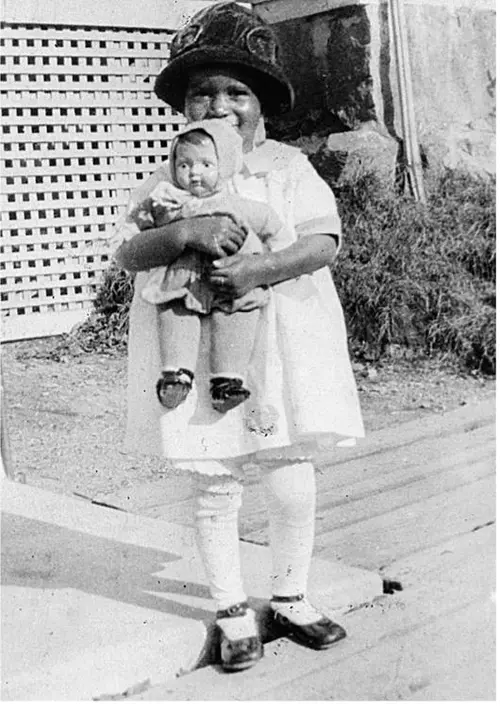 Little Elinor holding a doll in Milton, Massachusetts, circa 1924